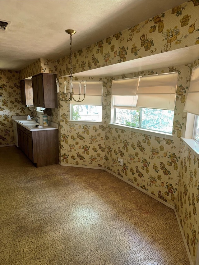 1815 Redwood St, Arlington, TX 76014 - unfurnished dining area with a chandelier, wallpapered walls, and light carpet