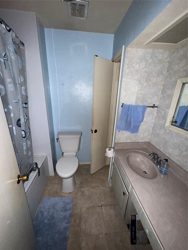 1815 Redwood St, Arlington, TX 76014 - full bathroom with vanity, shower / bath combo with shower curtain, and tile patterned floors