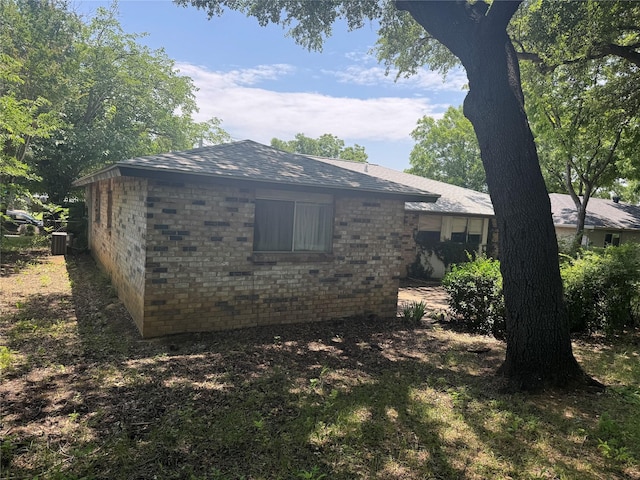 1815 Redwood St, Arlington, TX 76014 - view of home's exterior with a cooling unit and brick siding