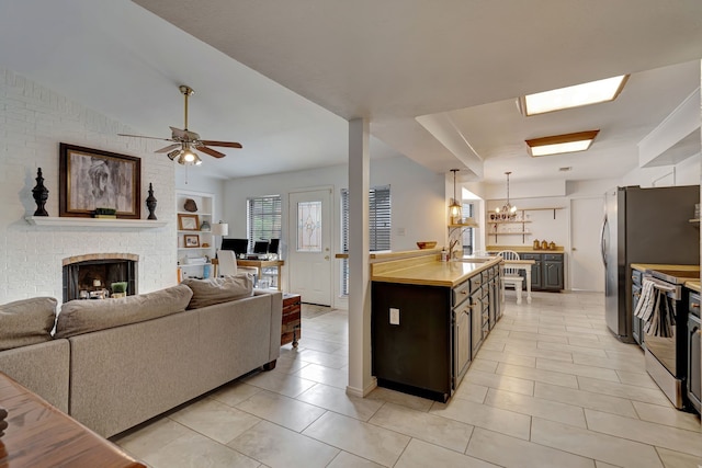 3909 Commonwealth Dr, Flower Mound, TX 75028 - kitchen featuring open floor plan, light countertops, electric stove, ceiling fan, and light tile patterned floors