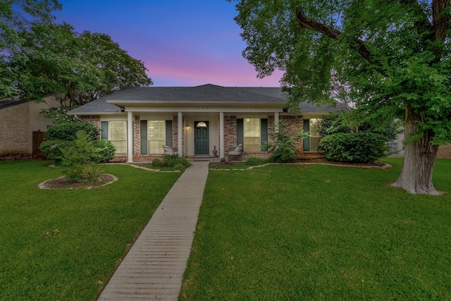 3909 Commonwealth Dr, Flower Mound, TX 75028 - view of front of home with brick siding, a front yard, and covered porch
