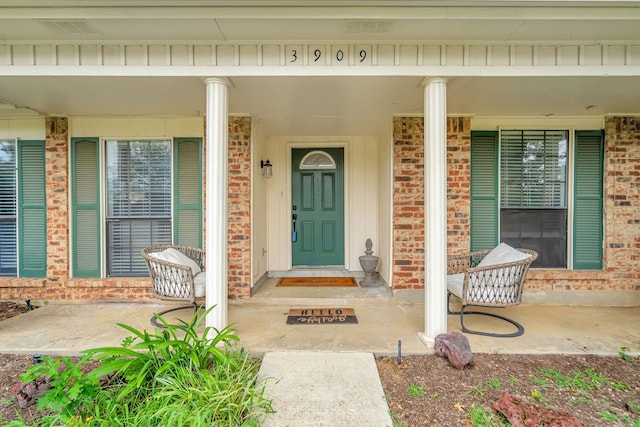 3909 Commonwealth Dr, Flower Mound, TX 75028 - doorway to property with brick siding and covered porch