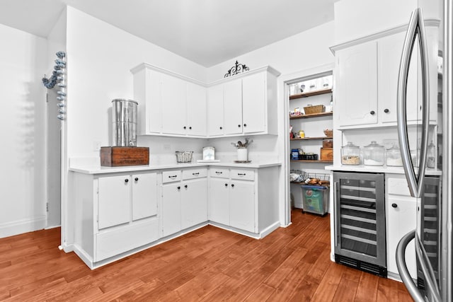 1056 Park Dr, Hillsboro, TX 76645 - kitchen featuring freestanding refrigerator, beverage cooler, and light countertops