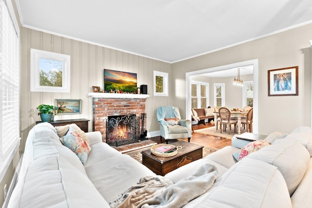 1056 Park Dr, Hillsboro, TX 76645 - living area featuring crown molding, wood finished floors, a fireplace, and a chandelier