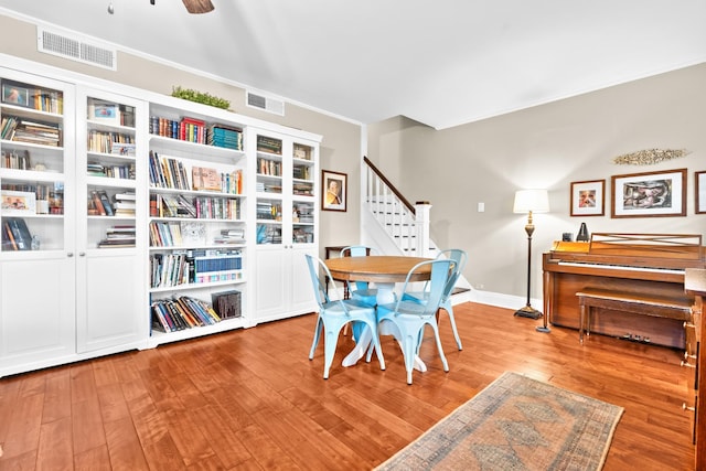 1056 Park Dr, Hillsboro, TX 76645 - dining space featuring wood finished floors, stairway, and ceiling fan