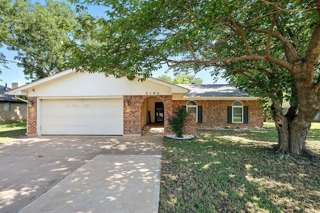 3102 Primrose Dr, Abilene, TX 79606 - single story home featuring driveway, a garage, brick siding, and a front lawn