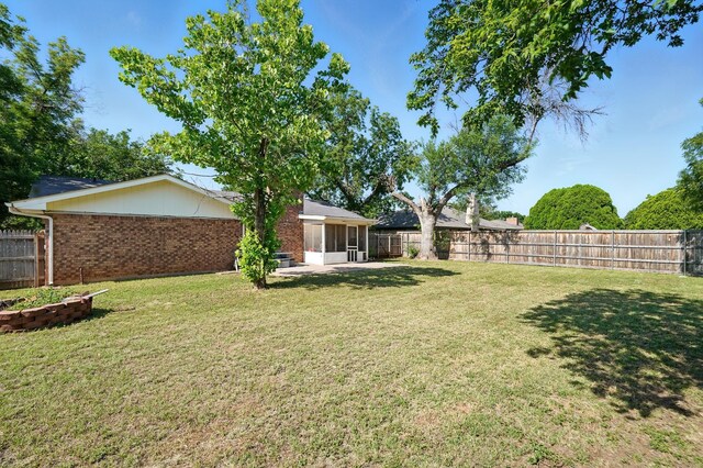 3102 Primrose Dr, Abilene, TX 79606 - fenced backyard with a sunroom