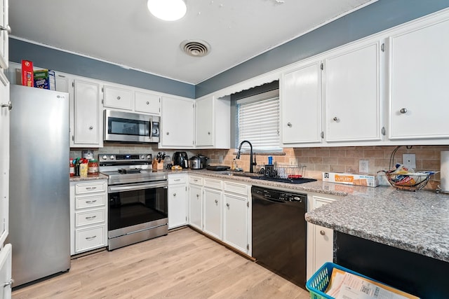 3102 Primrose Dr, Abilene, TX 79606 - kitchen with appliances with stainless steel finishes, backsplash, light wood finished floors, white cabinetry, and ornamental molding