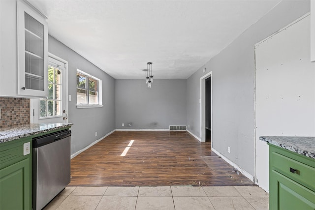 3312 Henry Dr, Richland Hills, TX 76118 - kitchen featuring stainless steel dishwasher, green cabinets, light wood-type flooring, and decorative backsplash