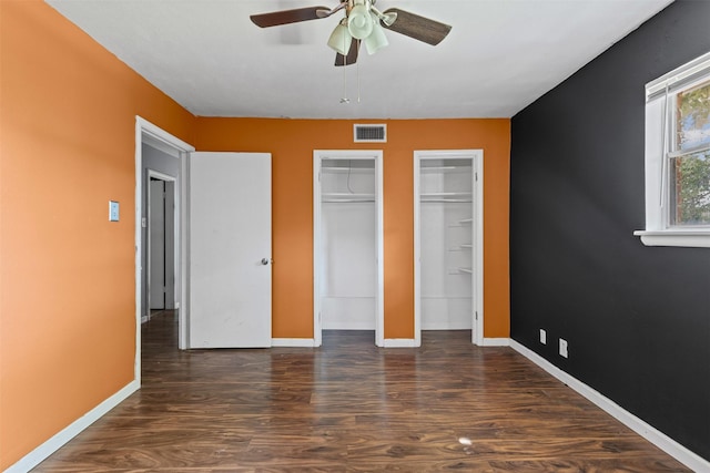 3312 Henry Dr, Richland Hills, TX 76118 - unfurnished bedroom featuring multiple closets, wood finished floors, and ceiling fan