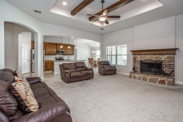 103 Loving Trl, Justin, TX 76247 - living area featuring light carpet, a raised ceiling, recessed lighting, a ceiling fan, and a fireplace