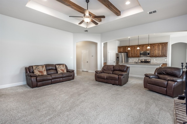 103 Loving Trl, Justin, TX 76247 - living room featuring arched walkways, a ceiling fan, light colored carpet, a tray ceiling, and recessed lighting