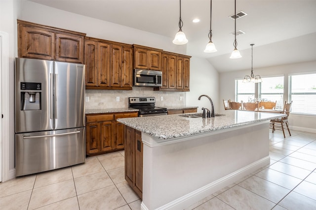 103 Loving Trl, Justin, TX 76247 - kitchen with stainless steel appliances, lofted ceiling, light tile patterned floors, tasteful backsplash, and light stone countertops