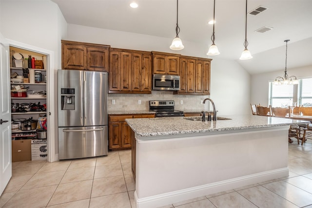103 Loving Trl, Justin, TX 76247 - kitchen featuring appliances with stainless steel finishes, vaulted ceiling, light stone counters, tasteful backsplash, and light tile patterned floors