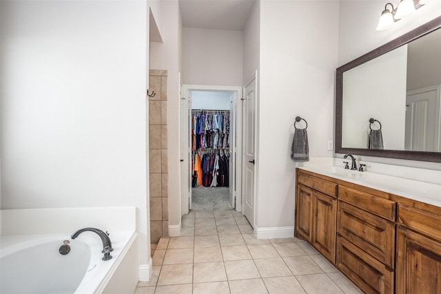 103 Loving Trl, Justin, TX 76247 - bathroom featuring a garden tub, vanity, tile patterned flooring, a walk in closet, and a shower
