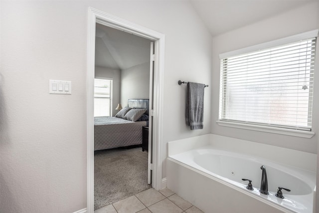 103 Loving Trl, Justin, TX 76247 - full bathroom featuring a jetted tub, tile patterned flooring, ensuite bath, and lofted ceiling