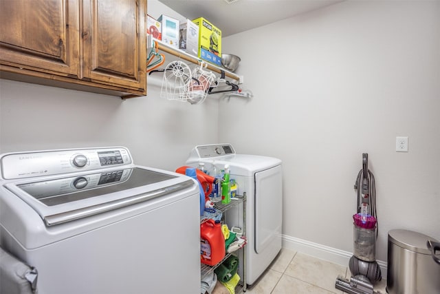 103 Loving Trl, Justin, TX 76247 - laundry room with independent washer and dryer, cabinet space, and light tile patterned flooring