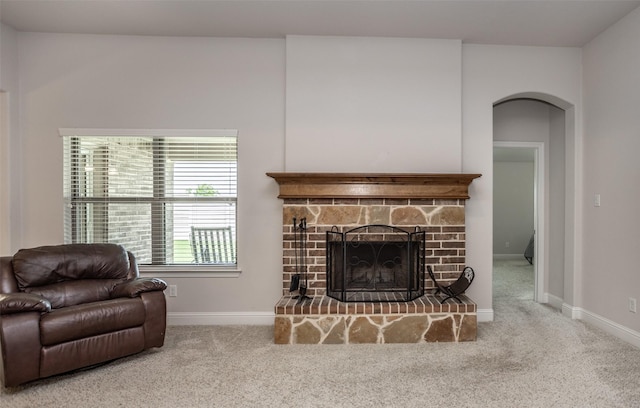 103 Loving Trl, Justin, TX 76247 - living area featuring carpet, arched walkways, and a fireplace