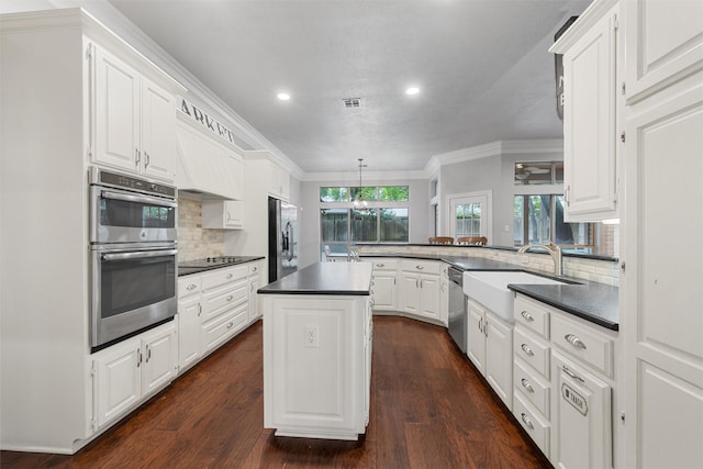 9604 Oak Springs Dr, Woodway, TX 76712 - kitchen with stainless steel appliances, dark countertops, recessed lighting, white cabinetry, and tasteful backsplash