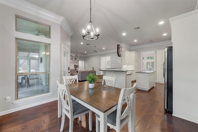 9604 Oak Springs Dr, Woodway, TX 76712 - dining space with a chandelier, a ceiling fan, recessed lighting, dark wood-style floors, and crown molding