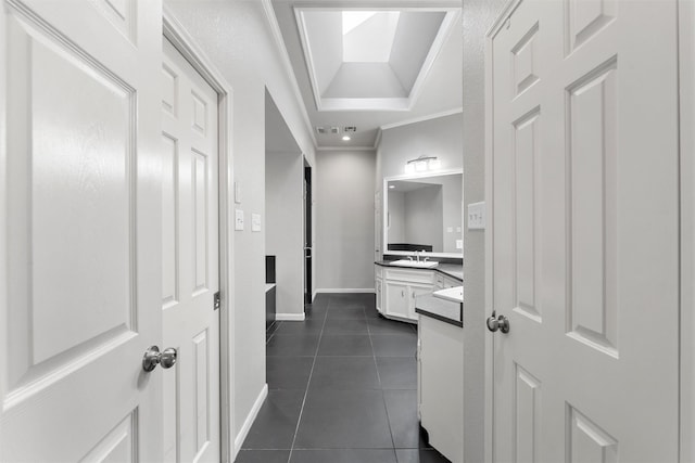 9604 Oak Springs Dr, Woodway, TX 76712 - hallway featuring crown molding, dark tile patterned floors, and a raised ceiling
