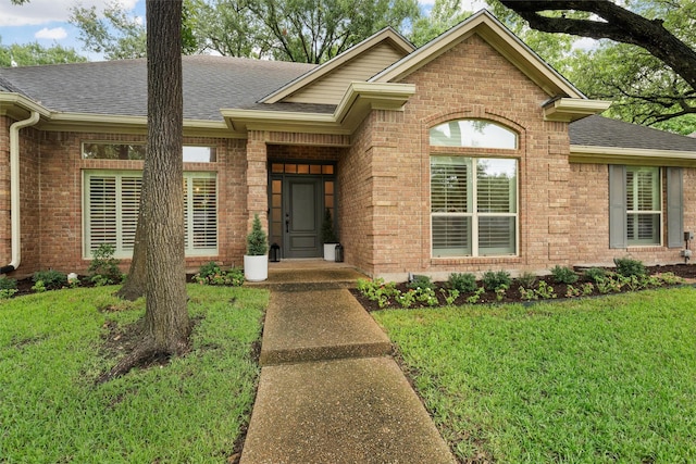 9604 Oak Springs Dr, Woodway, TX 76712 - view of front of house featuring roof with shingles, brick siding, and a front lawn