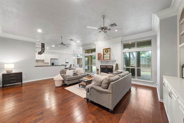 9604 Oak Springs Dr, Woodway, TX 76712 - living room featuring a ceiling fan, ornamental molding, a large fireplace, dark wood finished floors, and recessed lighting