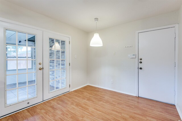 308 Woodhurst Pl, Coppell, TX 75019 - unfurnished dining area with french doors and light wood-style floors