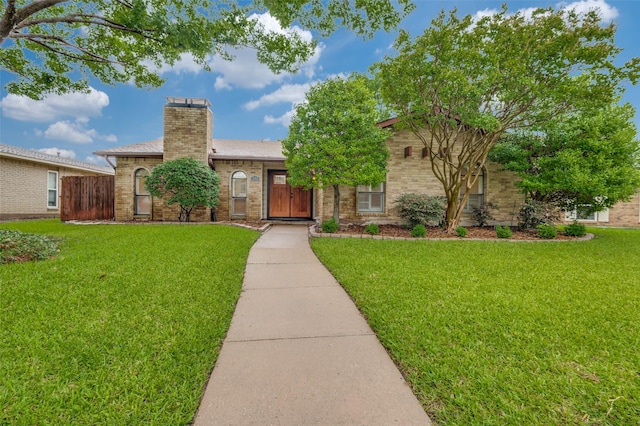 308 Woodhurst Pl, Coppell, TX 75019 - ranch-style house featuring a front yard, a chimney, and brick siding