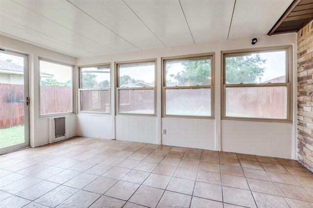 308 Woodhurst Pl, Coppell, TX 75019 - unfurnished sunroom with tile patterned floors and brick wall