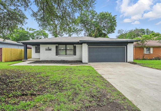 8620 Greenmound Ave, Dallas, TX 75227 - view of front of home with brick siding, a garage, and driveway