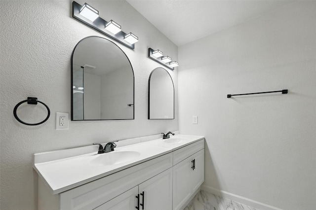 8620 Greenmound Ave, Dallas, TX 75227 - bathroom featuring double vanity and marble finish flooring