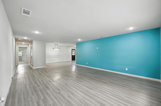8620 Greenmound Ave, Dallas, TX 75227 - unfurnished living room with recessed lighting and light wood-style floors