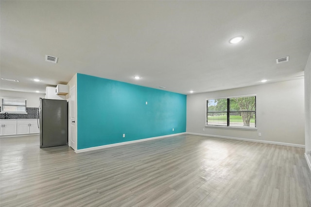 8620 Greenmound Ave, Dallas, TX 75227 - unfurnished living room featuring light wood finished floors and recessed lighting