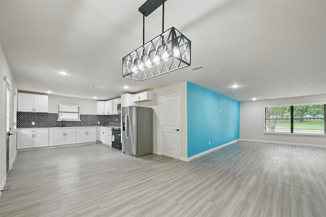 8620 Greenmound Ave, Dallas, TX 75227 - kitchen with stainless steel refrigerator with ice dispenser, stove, plenty of natural light, open floor plan, and recessed lighting