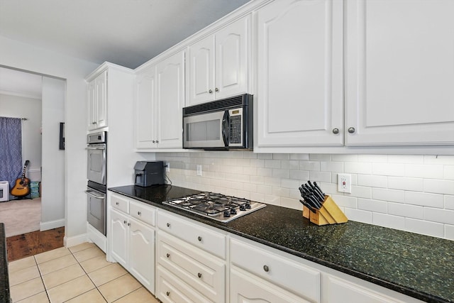 13272 Blue Jean Dr, Fort Worth, TX 76052 - kitchen featuring appliances with stainless steel finishes, white cabinetry, backsplash, and dark stone counters