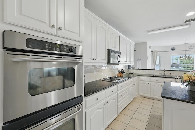 13272 Blue Jean Dr, Fort Worth, TX 76052 - kitchen featuring appliances with stainless steel finishes, white cabinets, and decorative backsplash