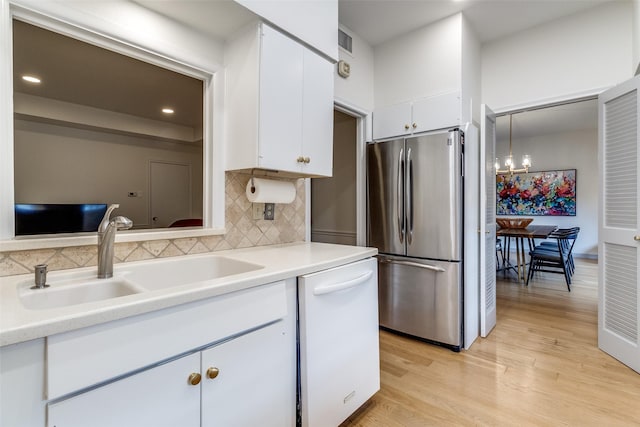 6328 Bandera Ave Unit C, Dallas, TX 75225 - kitchen with freestanding refrigerator, white dishwasher, white cabinetry, light countertops, and recessed lighting