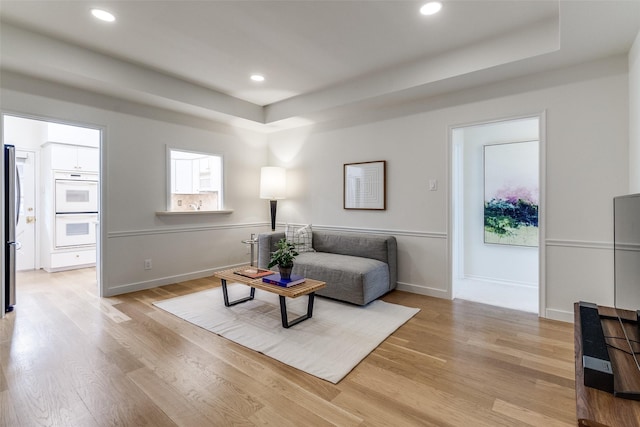 6328 Bandera Ave Unit C, Dallas, TX 75225 - living room featuring light wood finished floors, a raised ceiling, and recessed lighting