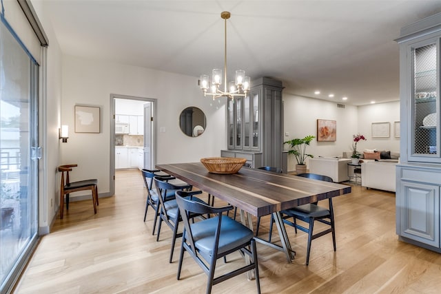 6328 Bandera Ave Unit C, Dallas, TX 75225 - dining area featuring light wood finished floors, a chandelier, and recessed lighting
