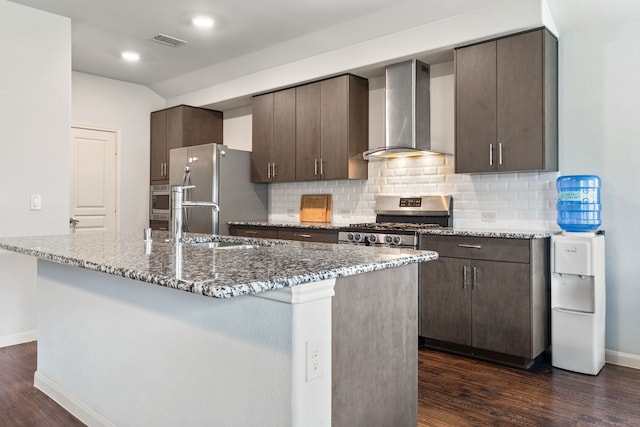 1108 Sheldon Dr, Anna, TX 75409 - kitchen with wall chimney exhaust hood, appliances with stainless steel finishes, dark brown cabinetry, dark wood finished floors, and backsplash