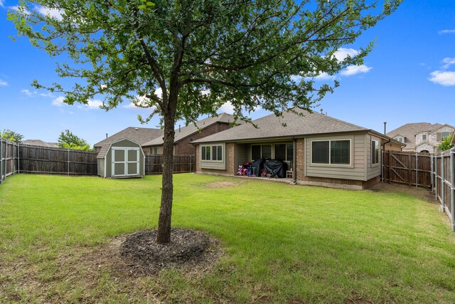 1108 Sheldon Dr, Anna, TX 75409 - back of house featuring a storage unit, a fenced backyard, brick siding, and roof with shingles