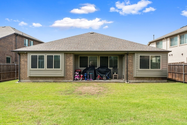 1108 Sheldon Dr, Anna, TX 75409 - back of property featuring brick siding, a fenced backyard, and a shingled roof