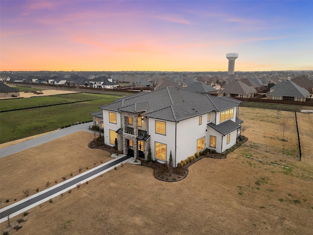 7604 Nocona Dr, Parker, TX 75098 - rear view of property with stucco siding, a residential view, stone siding, and driveway