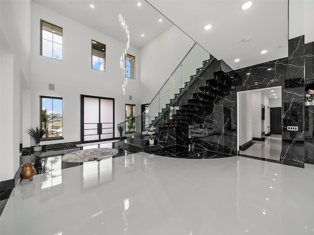 7604 Nocona Dr, Parker, TX 75098 - staircase with recessed lighting, a high ceiling, healthy amount of natural light, and marble tiled floors