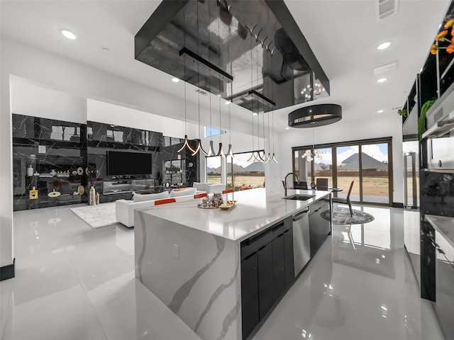 7604 Nocona Dr, Parker, TX 75098 - kitchen featuring a towering ceiling, modern cabinets, a center island with sink, decorative light fixtures, and recessed lighting