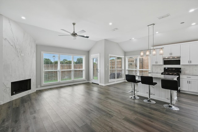2528 Forestwood Dr, Flower Mound, TX 75028 - kitchen featuring black range with gas cooktop, open floor plan, a ceiling fan, dark wood-type flooring, and lofted ceiling