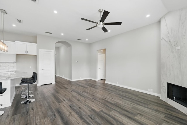2528 Forestwood Dr, Flower Mound, TX 75028 - unfurnished living room with arched walkways, ceiling fan, dark wood-type flooring, recessed lighting, and a fireplace