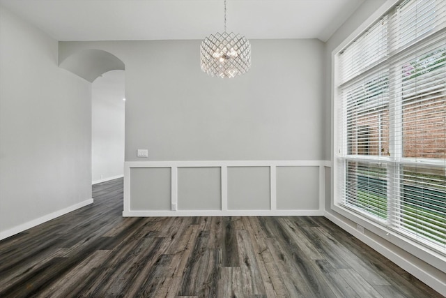 2528 Forestwood Dr, Flower Mound, TX 75028 - unfurnished dining area with dark wood finished floors, healthy amount of natural light, a chandelier, and arched walkways