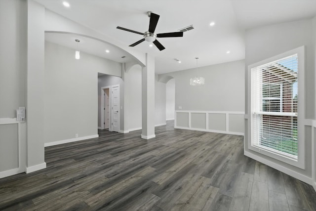 2528 Forestwood Dr, Flower Mound, TX 75028 - unfurnished living room featuring arched walkways, dark wood-type flooring, a ceiling fan, recessed lighting, and a chandelier